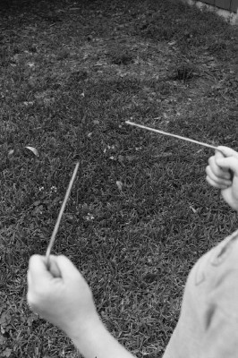 Figure 3. How dowsing rods would appear as a user approached a buried object. The angle the rods is about equal, indicating she is headed directly toward it.